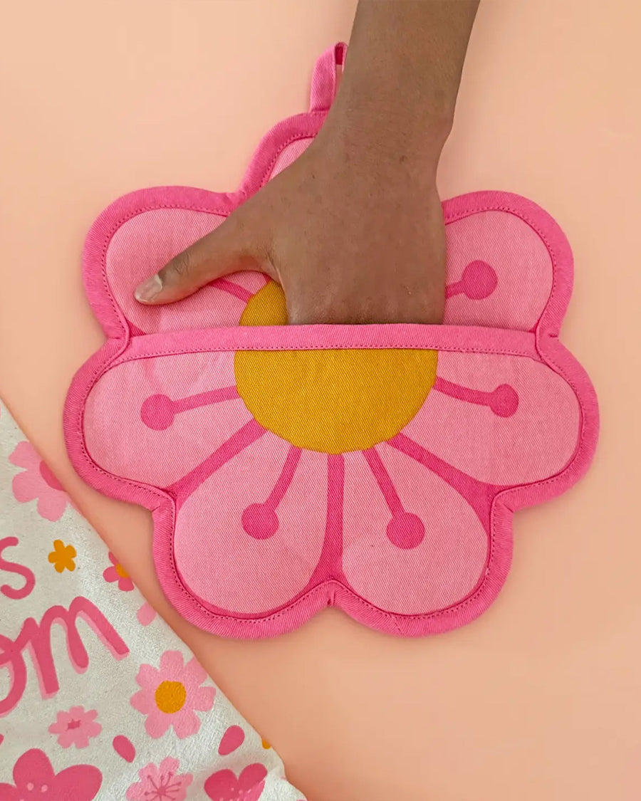 model putting hand in pink blossom pocket pot holder