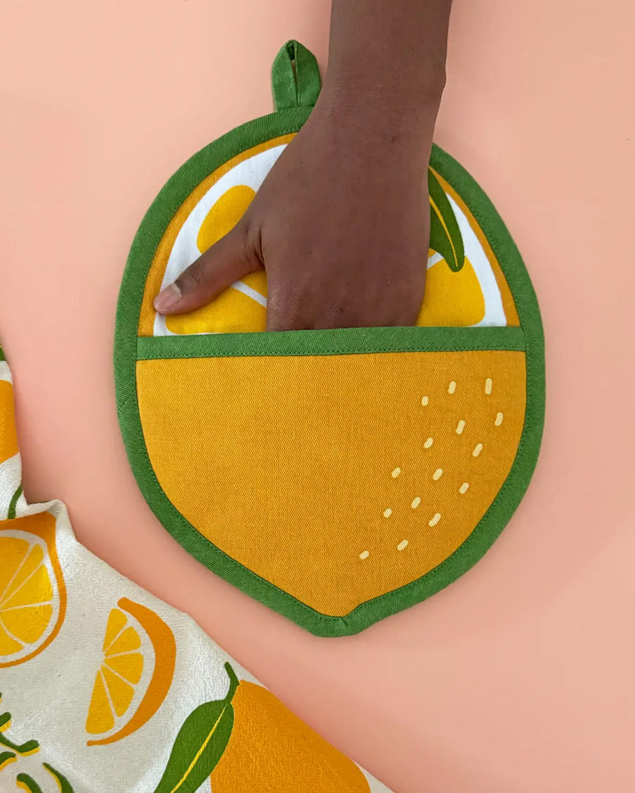 model putting hand in lemon pocket pot holder