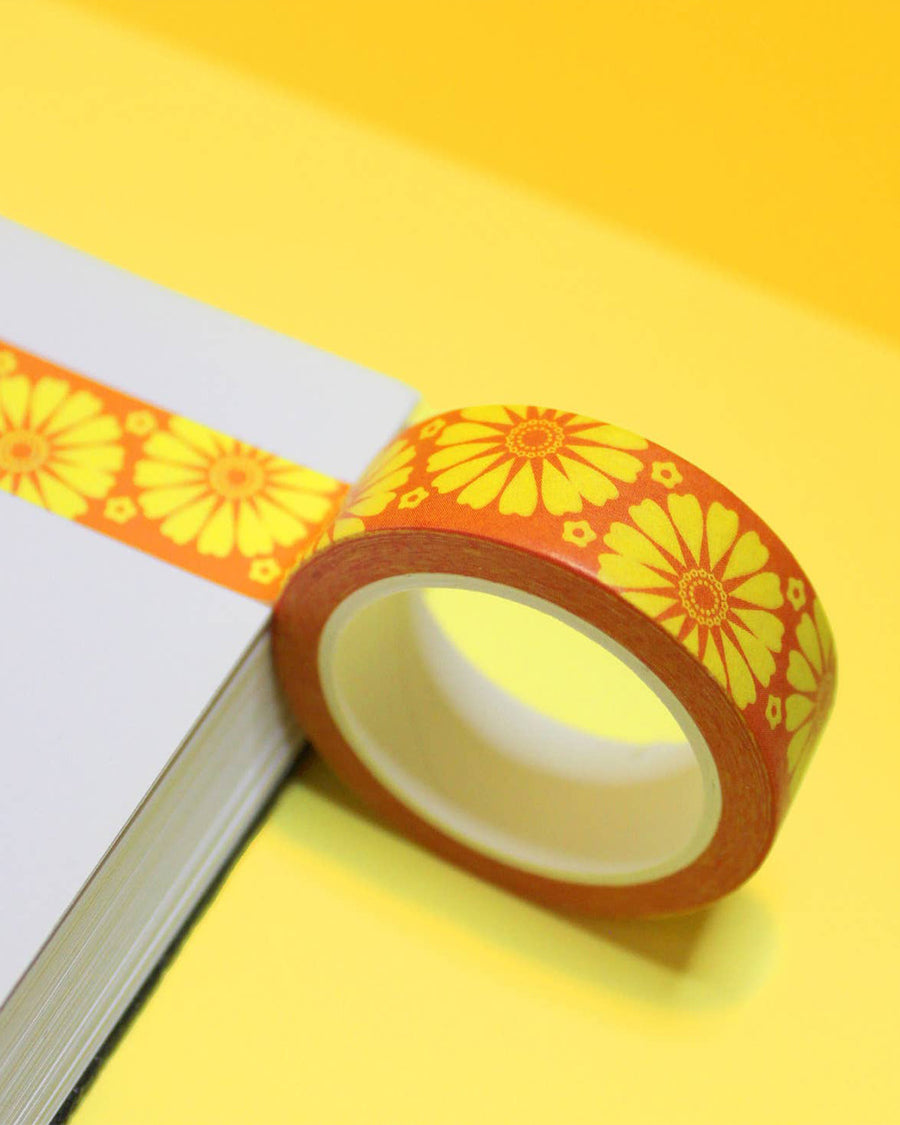 roll of orange washi tape with yellow retro pyrex floral print