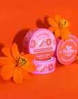 packaged roll of pink washi tape with yellow and orange retro floral print