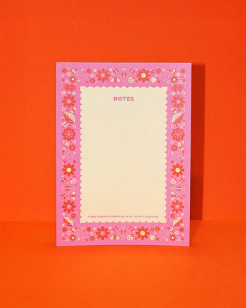 notepad with pink border with flower, leaves and butterfly print