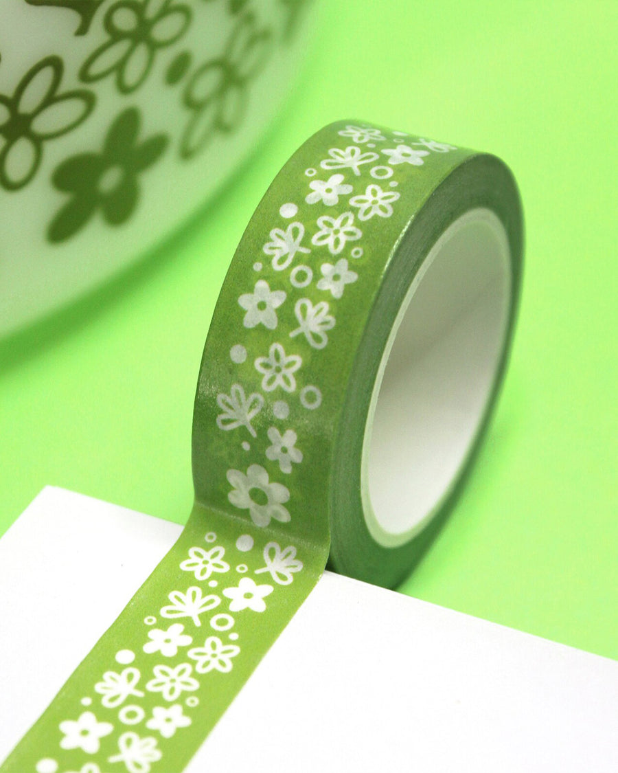 up close of roll of green washi tape with vintage white pyrex floral print