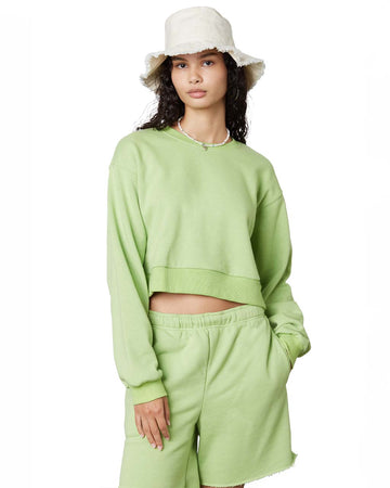 model wearing match green cropped pullover sweatshirt with matching shorts