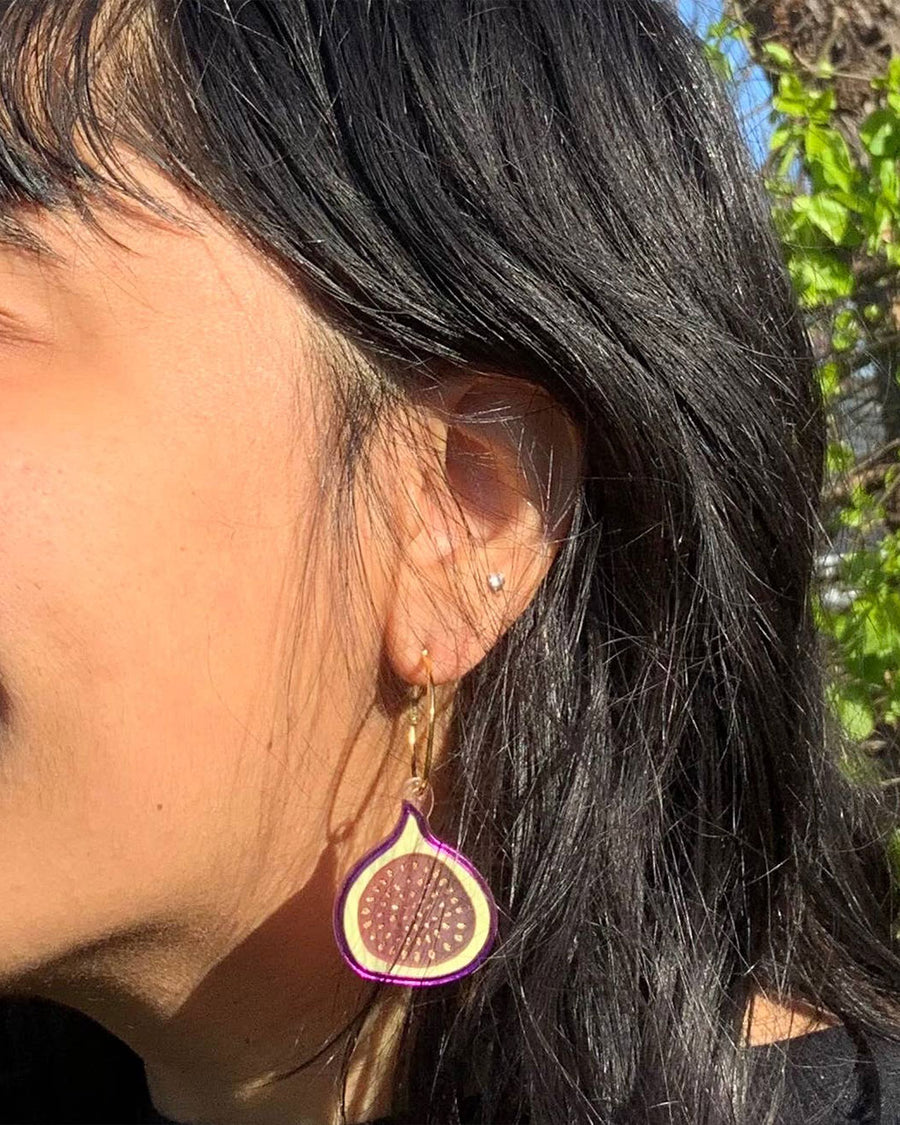 model wearing fig earrings on gold hoops