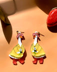 goose wearing yellow coat, pink boots and hat dangle earrings