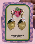 lemon shaped dangle earrings with flower on top on not picasso card