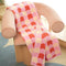 coral, pink and white checked pattern towel on a chair