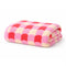 folded coral, pink and white checked towel