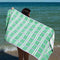 models holding reversible green with cream and lilac stripes towel