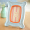 side view of white abstract 4 x 6 picture frame with orange interior trim