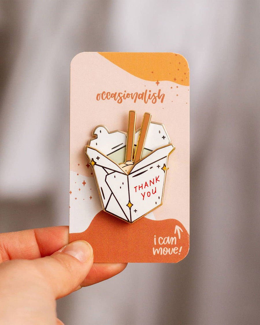 model holding white take out box enamel pin with movable noodle piece