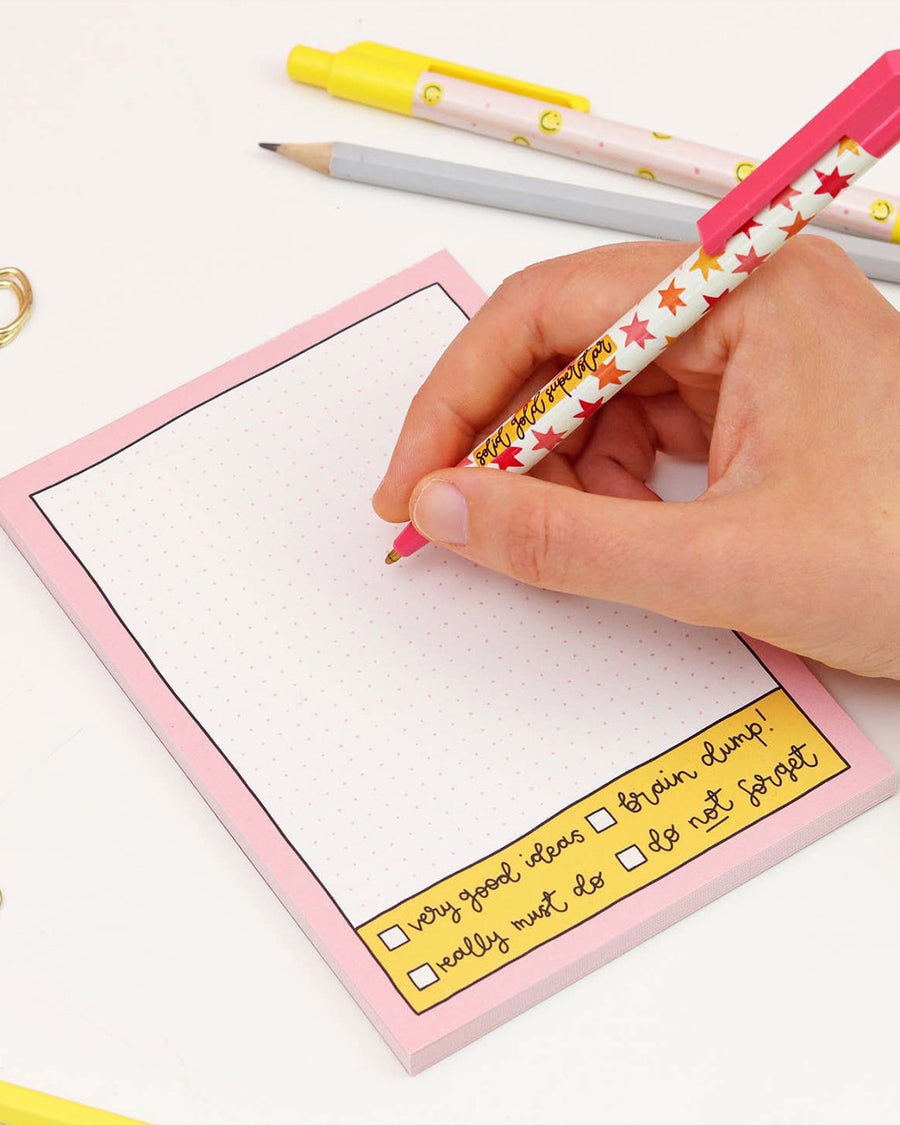 model using grid notepad with pink border and bottom checklist
