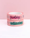pink rolls of washi take with days of the week in cursive and color stripes through them