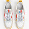 top view of white sneakers with orange, yellow and blue retro accents