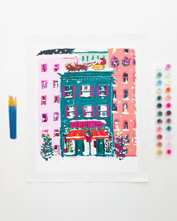 painted holiday bookstore paint by numbers kit with pots of paint and paintbrushes