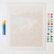 unpainted paint by numbers kit with colorful beach image, paint brushes and pots of paint