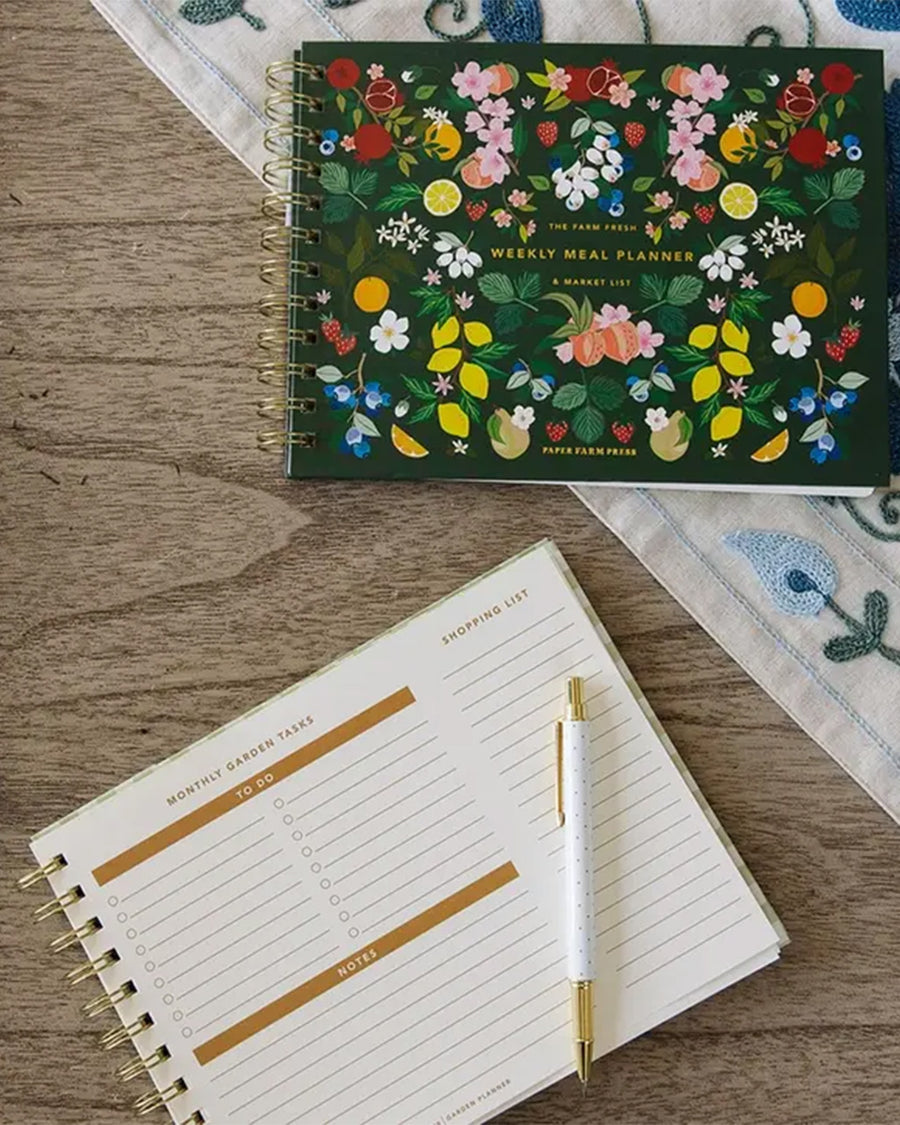 the farm fresh weekly meal planner & market list with colorful fruit and floral print cover with interior pages showing