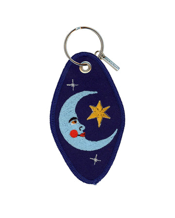 dark blue hotel keychain with blue moon and star print