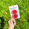 model holding set of 2 red large button hair clips