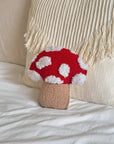 red and white mushroom shaped throw pillow