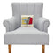 cream square throw pillow with two sardines in a red tin on a chair