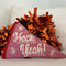 pink pennant flag throw pillow with 'heck yeah!' across the front with orange pom poms behind it