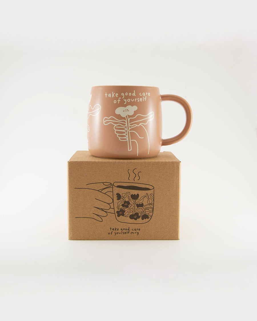 peach take good care of yourself mug with white flower print and box
