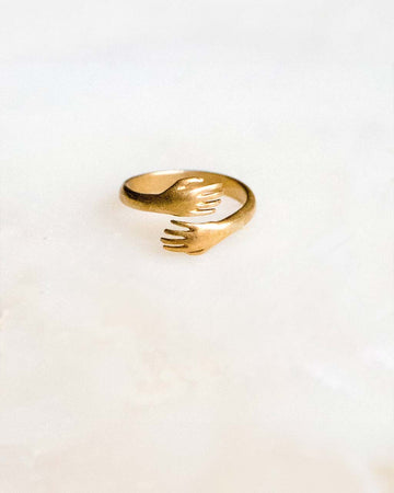 small gold hands ring