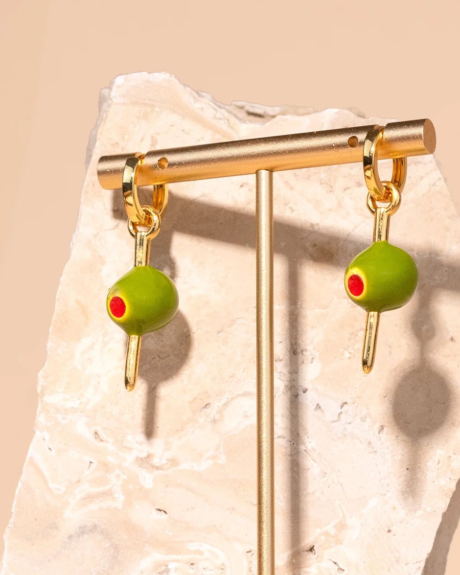 displayed green olive hoop dangle earrings with a gold 'toothpick' through it