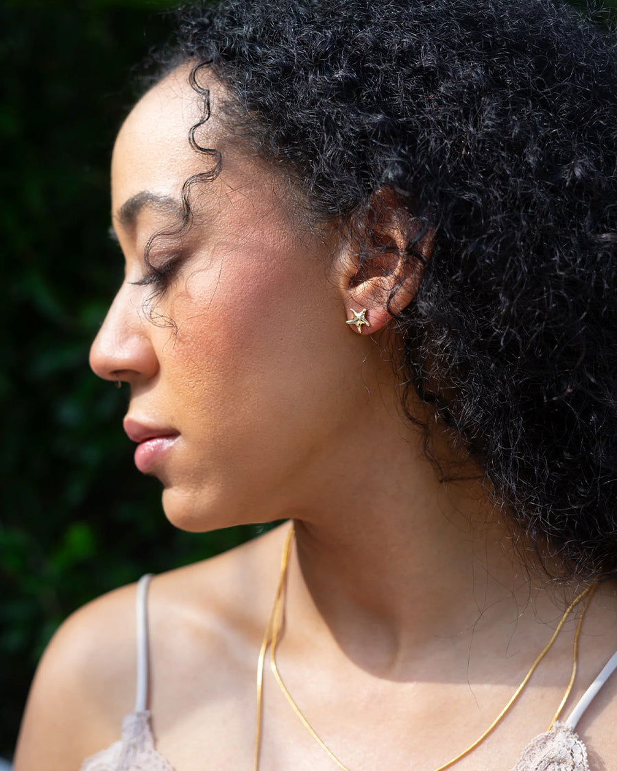 model wearing silver starfish stud earrings