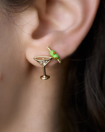 model wearing set of two stud earrings: martini glass and two olives on a skewer