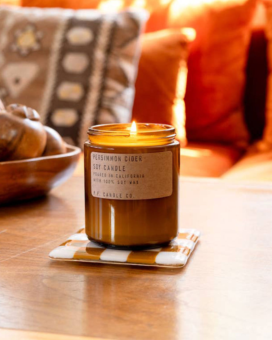 persimmon cider scented candle in fall themed room
