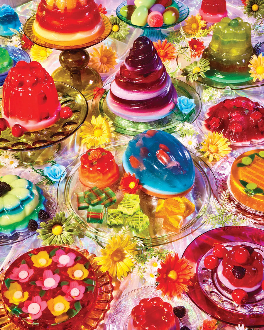 completed puzzle of  'had me at jello' 1000 piece puzzle with various colorful jello desserts on a table