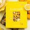 boxed 1000 piece puzzle with lemon inspired pastries and desserts on a striped tablecloth