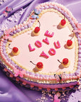 up close of 70 piece mini puzzle with a heart shaped cake with 'love you' on it