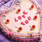 up close of 70 piece mini puzzle with a heart shaped cake with 'love you' on it