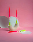 red, pink, light blue and neon green twisted candle set of 3 in a candle holder