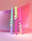 set of three twisted taper candles in pink, yellow, purple and aqua 