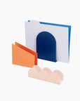 set of three 'forms' desk organizers: blue arch, orange parallelogram, and blush scallop