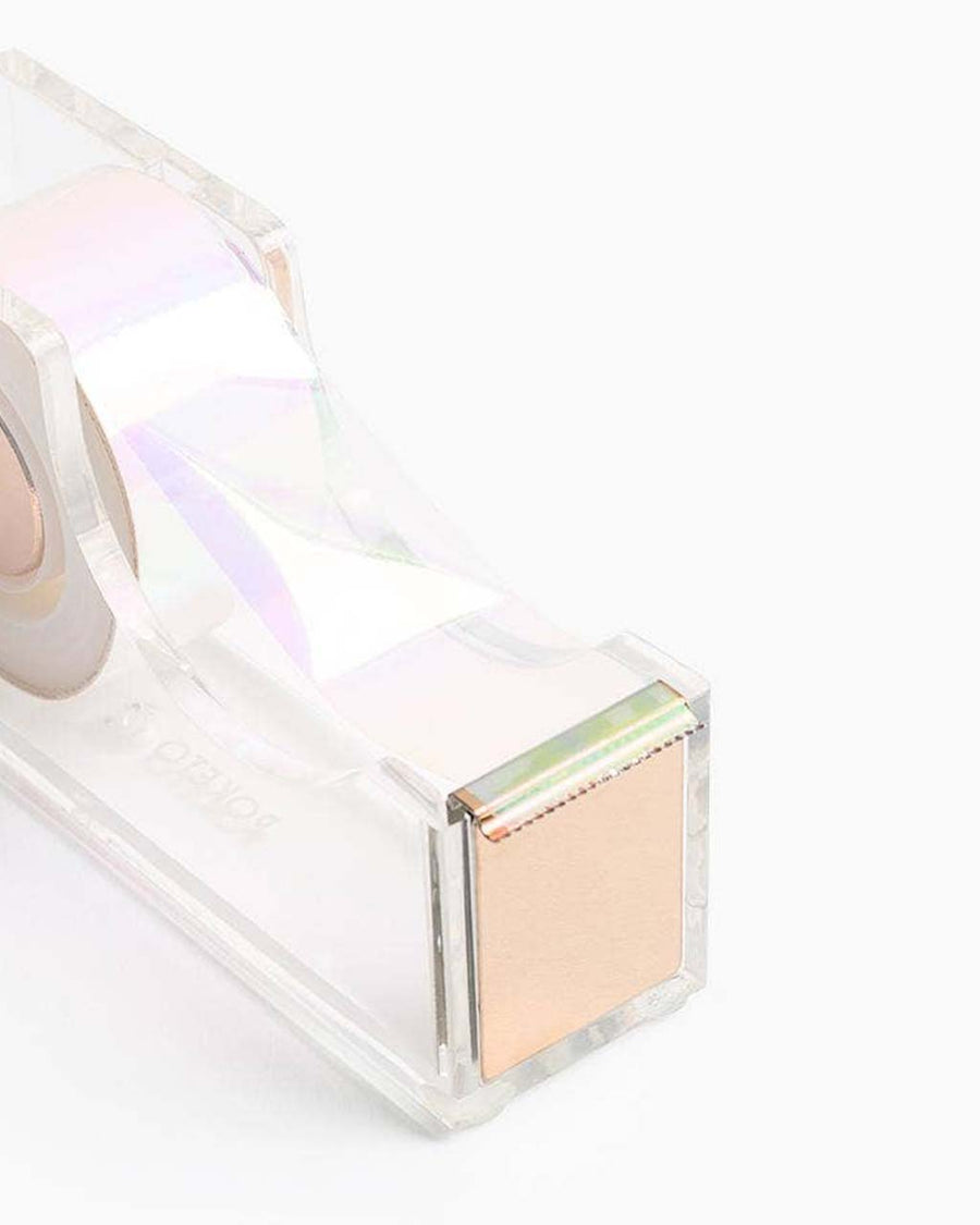 up close of clear lucite tape dispenser with gold accents