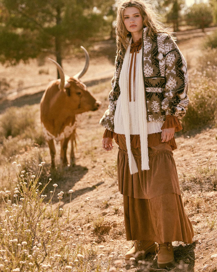 model wearing brown and white geometric zip up sherpa sweatshirt with faux leather trim