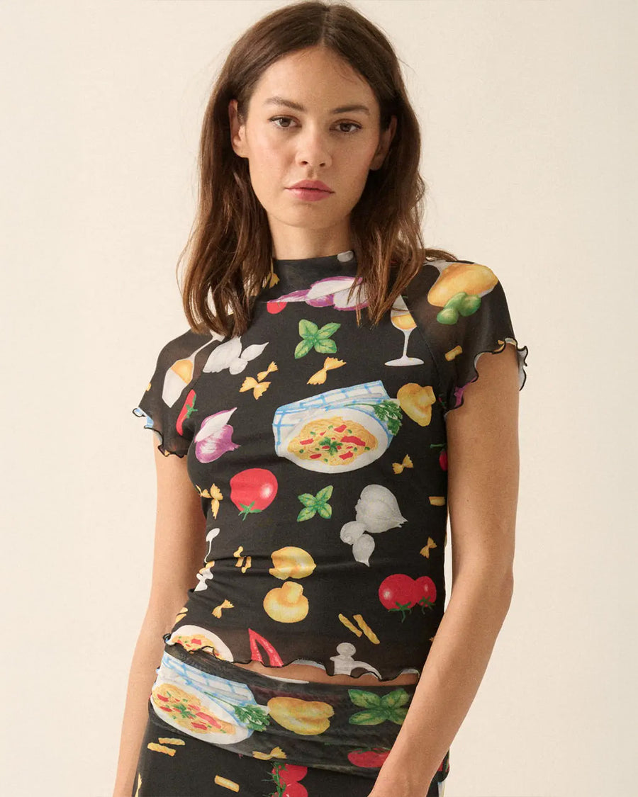 model wearing black fitted mesh top with ruffle sleeves and all over pasta and veggie print
