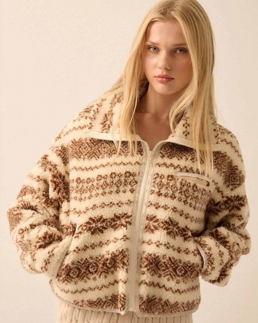model wearing cropped white zip up jacket with brown alpine print