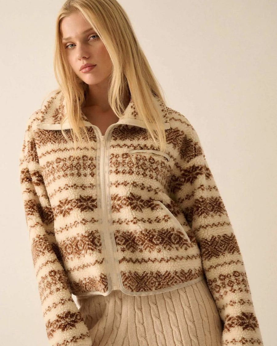 model wearing cropped white zip up jacket with brown alpine print