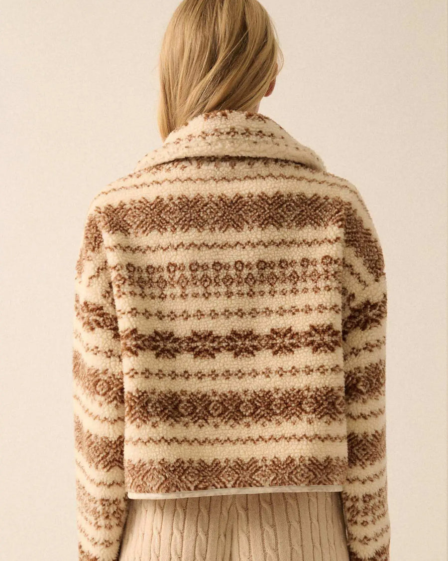 back view of model wearing cropped white zip up jacket with brown alpine print