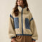model wearing cream sherpa zip-up jacket with blue denim trim with a high neck collar
