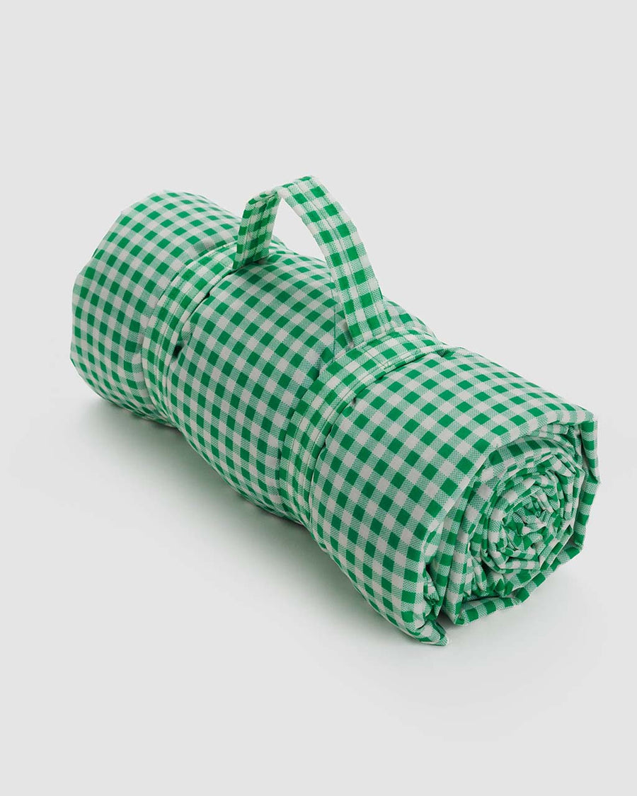 rolled up green and white gingham puffy picnic blanket