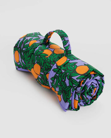 rolled up periwinkle orange tree puffy picnic blanket