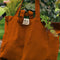 terracotta cotton tote bag with greens inside