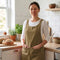 front view of model wearing green criss-cross back apron